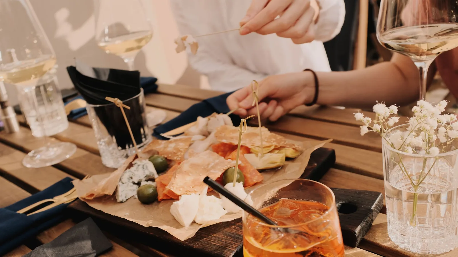 Wine, cheese and spritz on a wooden table