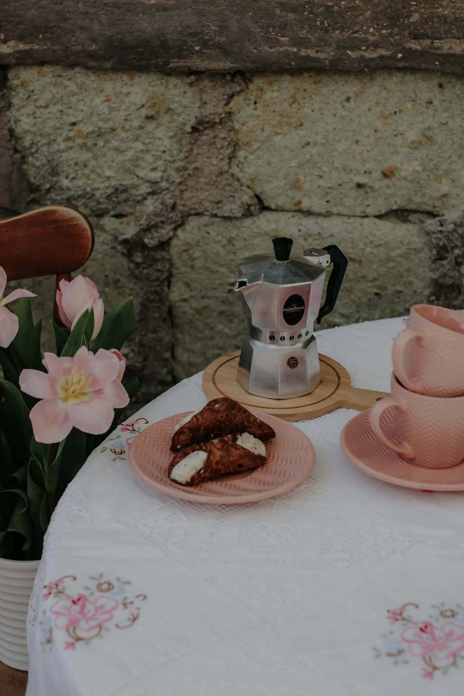 Coffee pot and pastries on a small table