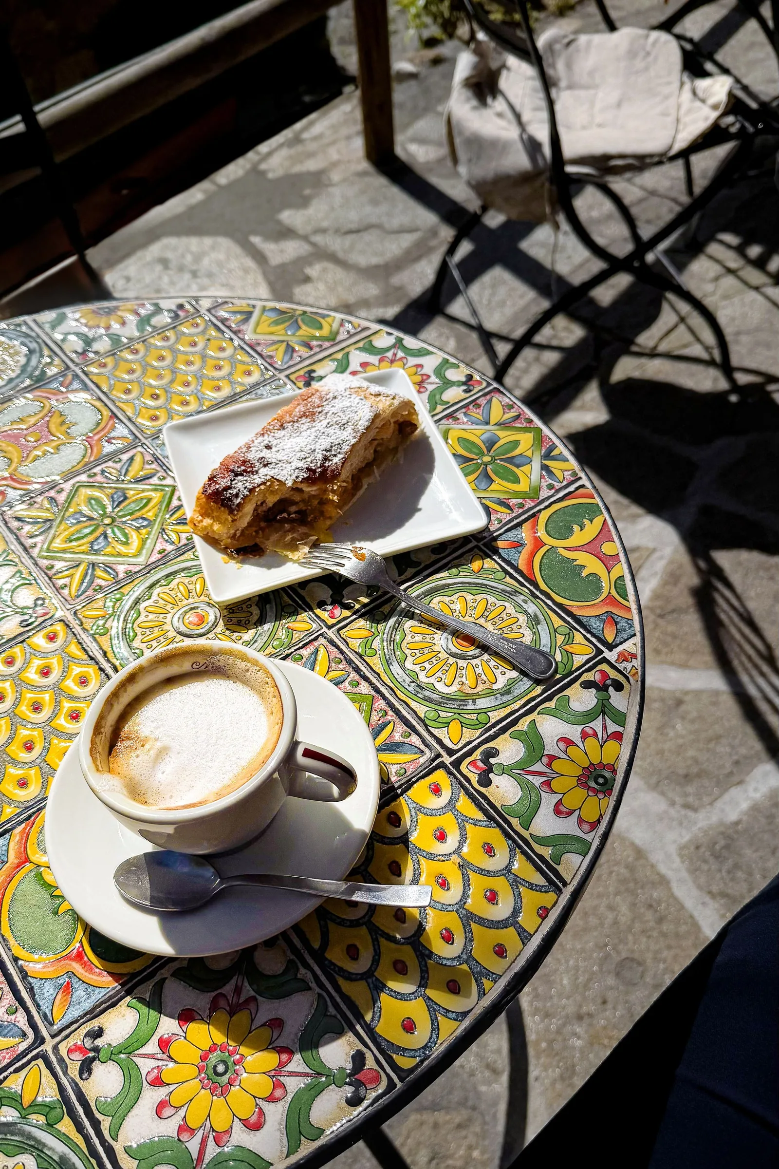 Cappuccino and pastry on a painted table