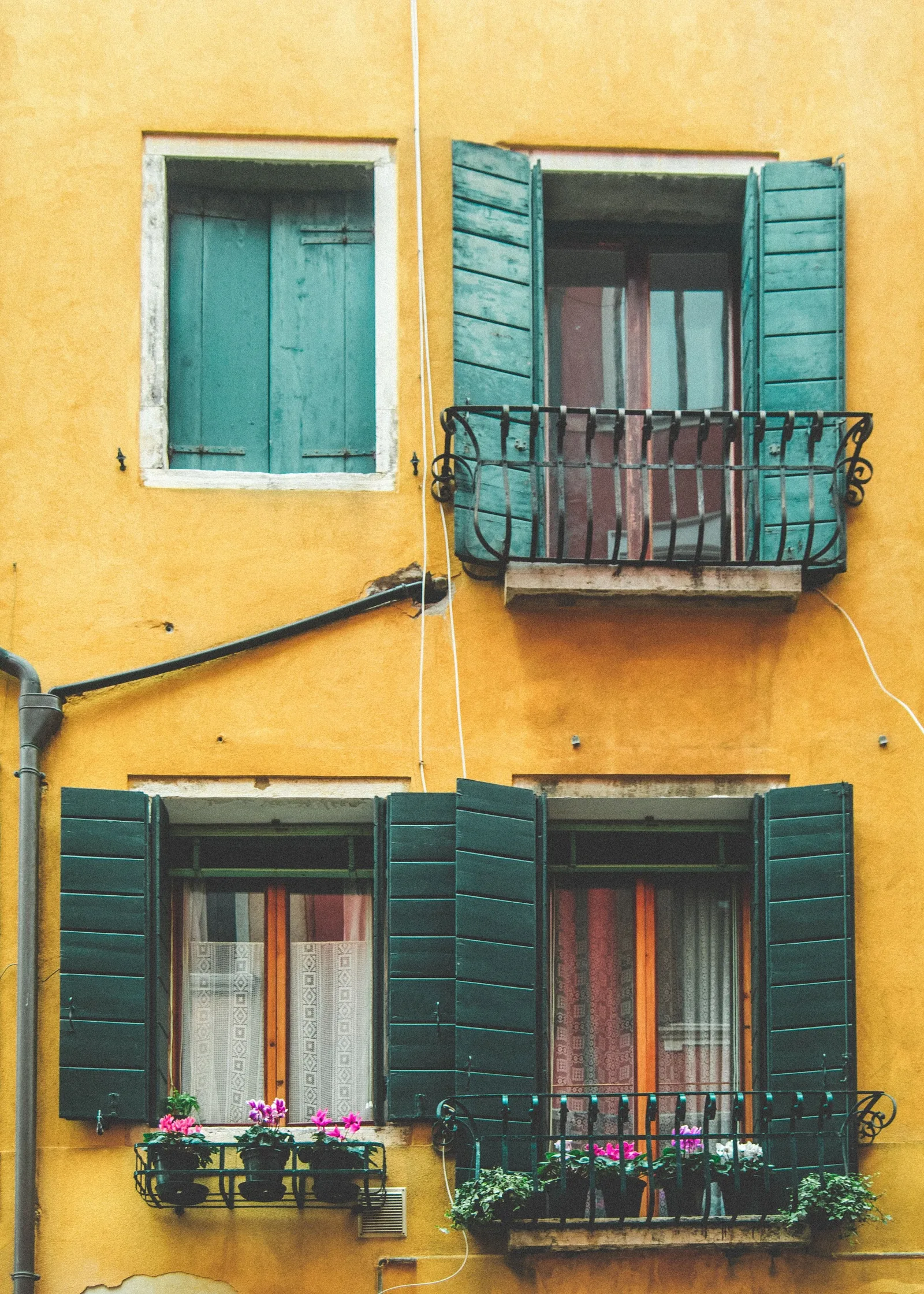 Yellow facade with a small iron balcony