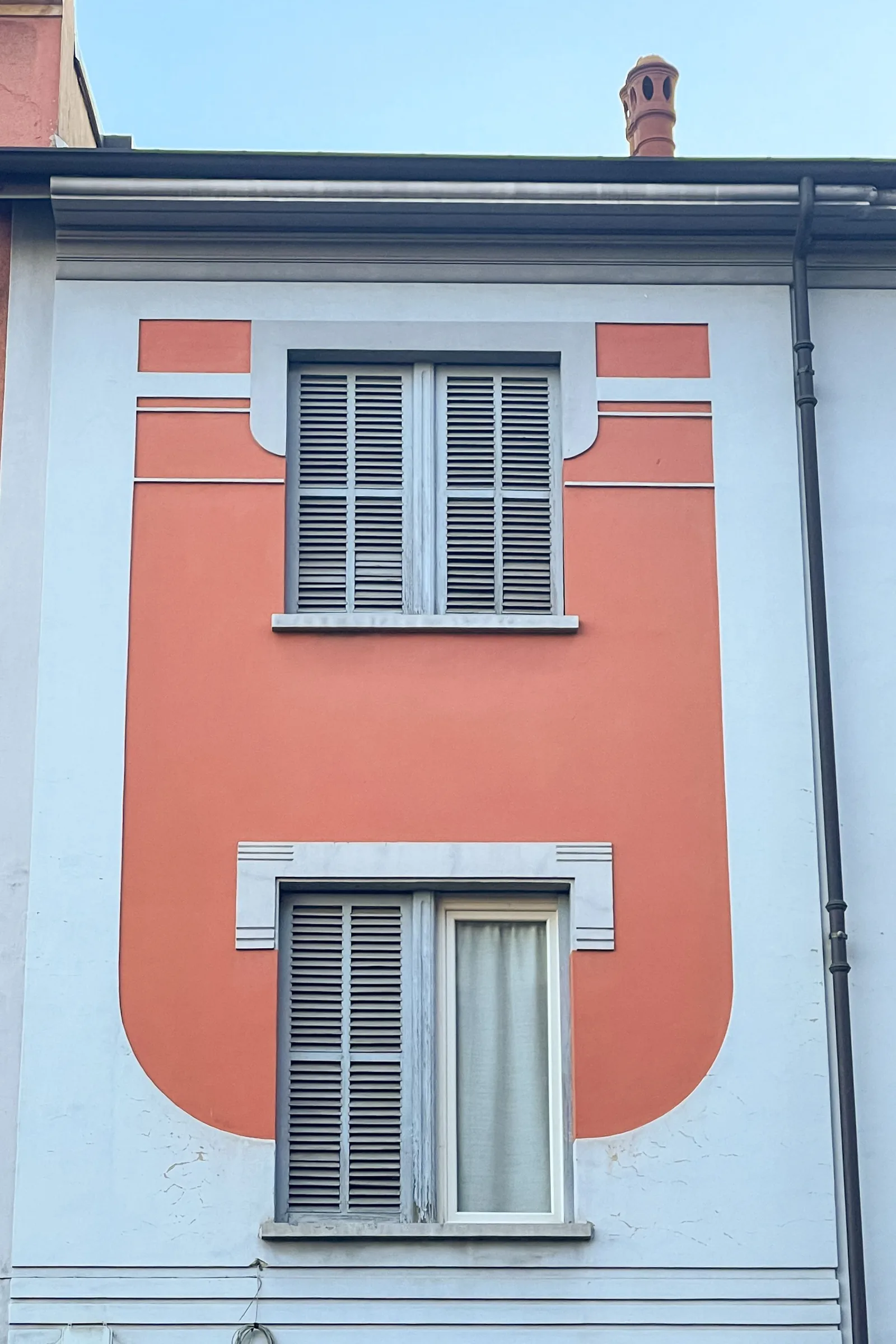 Orange facade with grey shutters