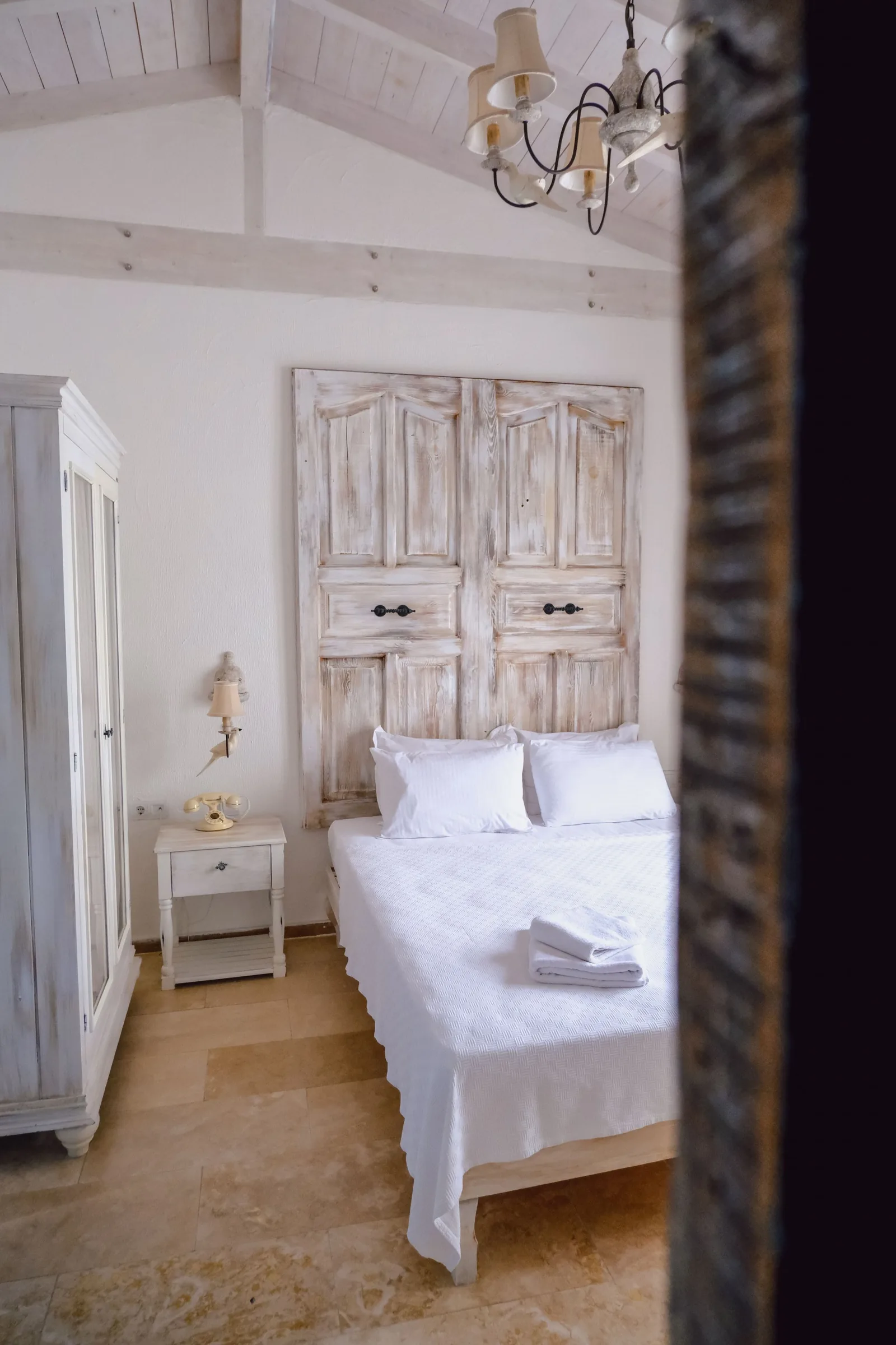 Small white room with a single bed
